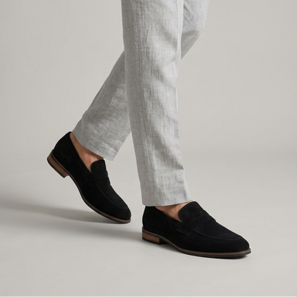 Men's black synthetic loafers with classic strap detail and slip-on design for formal and smart casual outfits