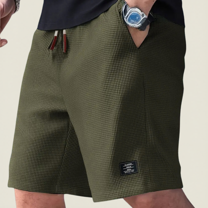 Men's dark green lightweight summer shorts with regular fit and elasticated waist for relaxed summer outfits