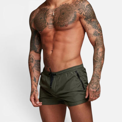 Men's dark green stretch swim trunks with quick-dry design and adjustable drawstring waist
