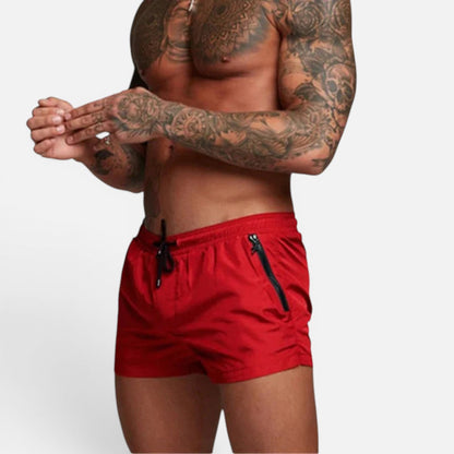 Men's orange stretch swim trunks with quick-dry design and adjustable drawstring waist
