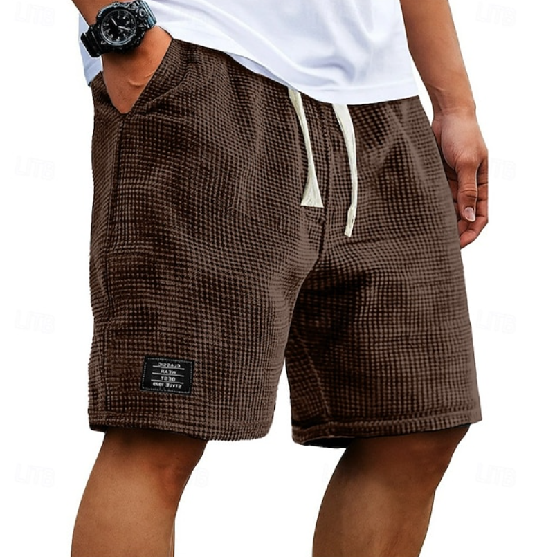 Men's white waffle shorts with relaxed fit, textured fabric, drawstring waist and side pockets