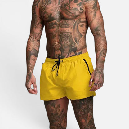 Men's yellow stretch swim trunks with quick-dry design and adjustable drawstring waist